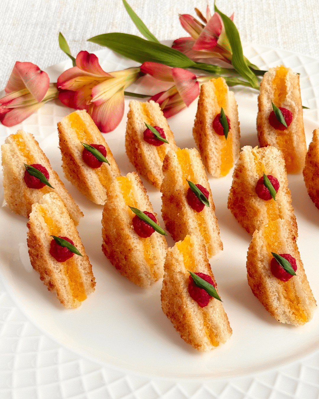 Grilled cheese soldiers topped with tomato and basil