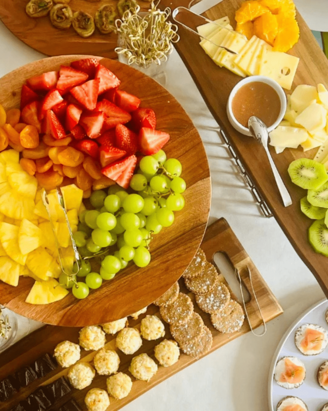 Fruit and cheese grazing board with strawberries, grapes and pineapple