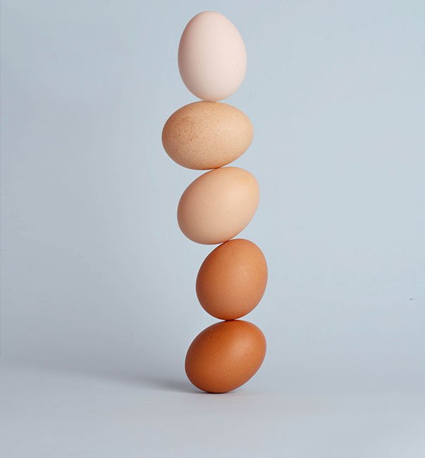 Five eggs balanced in a vertical stack, symbolising balance