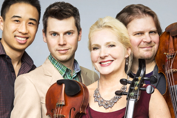 Four classical musicians holding string instruments, smiling