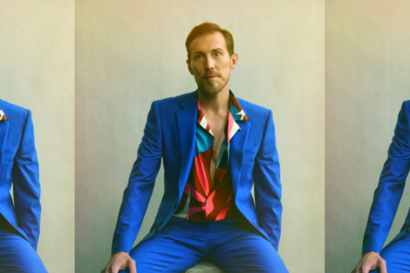 Michael Inge in a vivid blue suit in a mirrored composition
