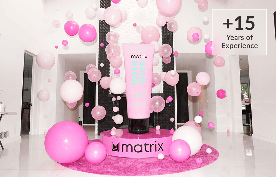 Matrix hair-care activation with a giant product tube surrounded by pink balloons