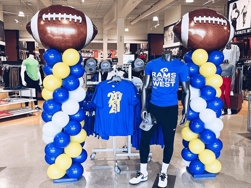 Sporting-goods store with LA Rams blue and gold balloon columns topped with football foil balloons
