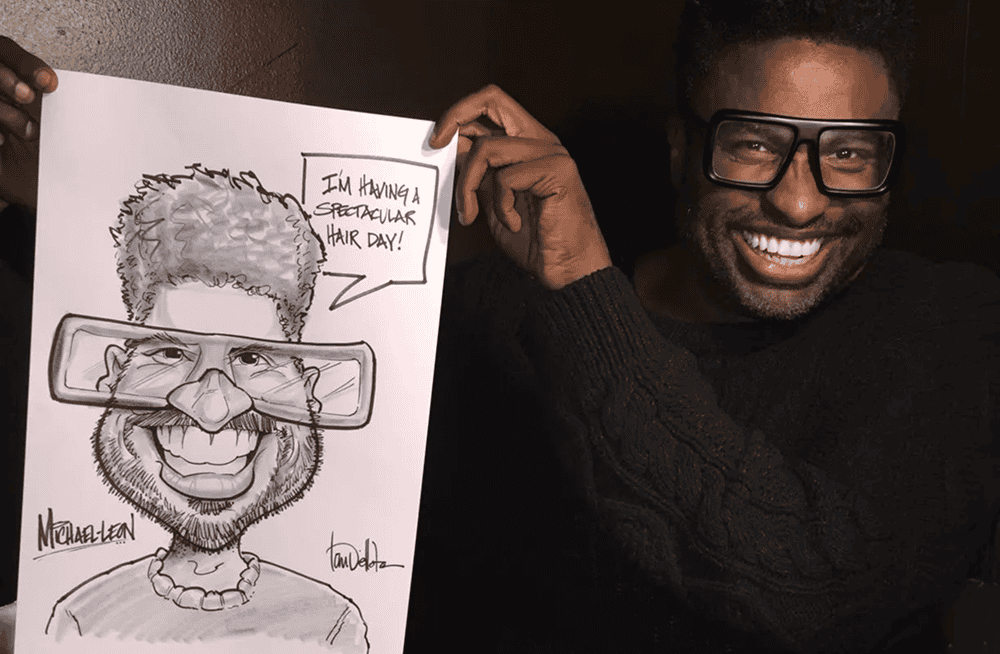 Guest holding up a caricature drawing of himself at an event