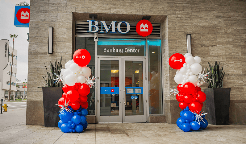 BMO Bank storefront with red, white and blue balloon columns flanking the entrance