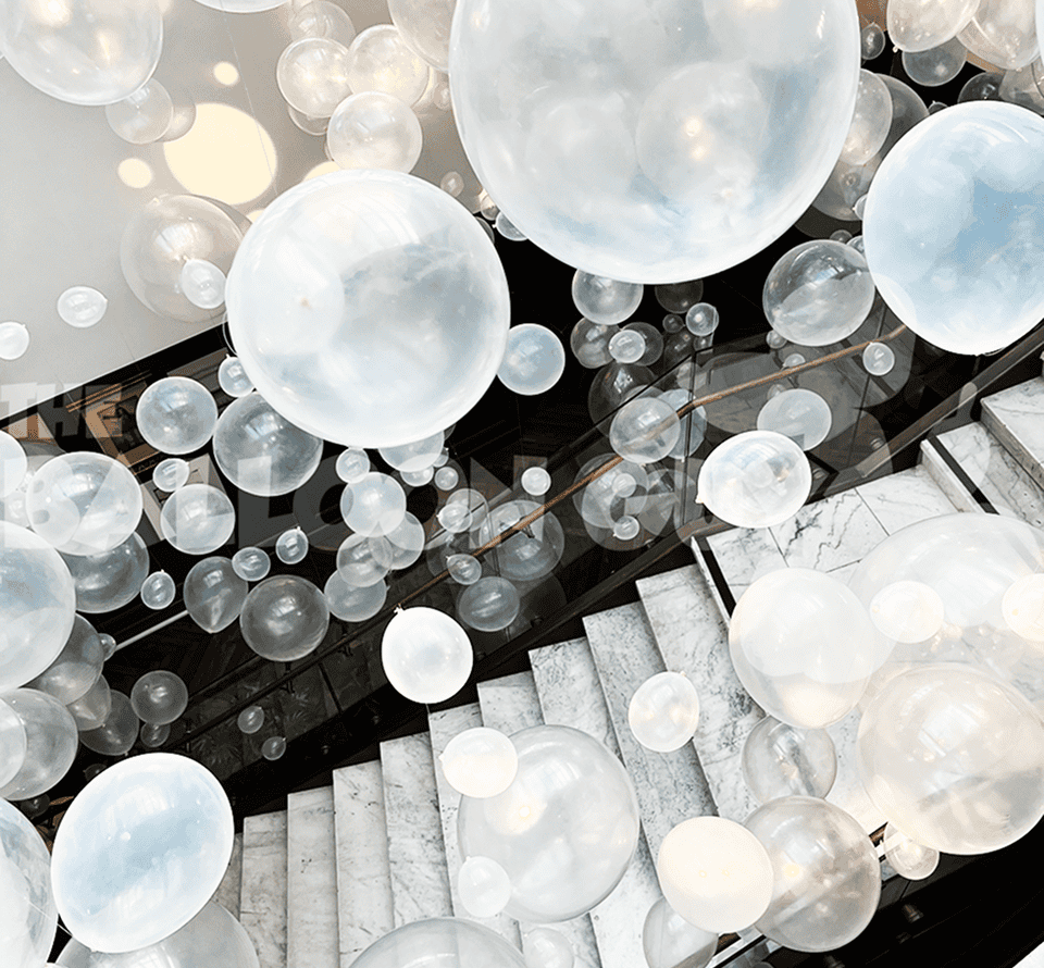 Clear bubble balloons over a marble staircase
