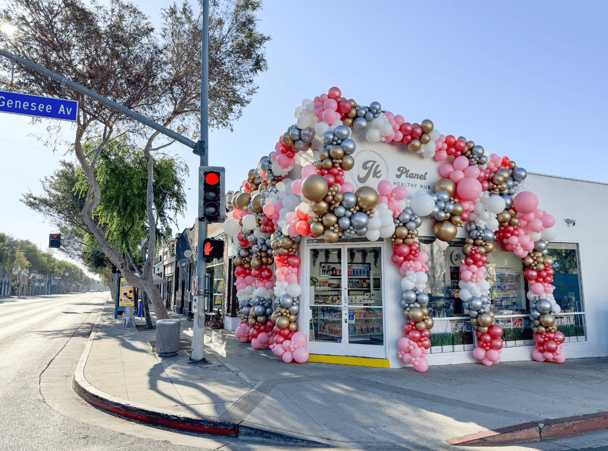 West Hollywood corner storefront covered in a pink, silver and gold balloon arch