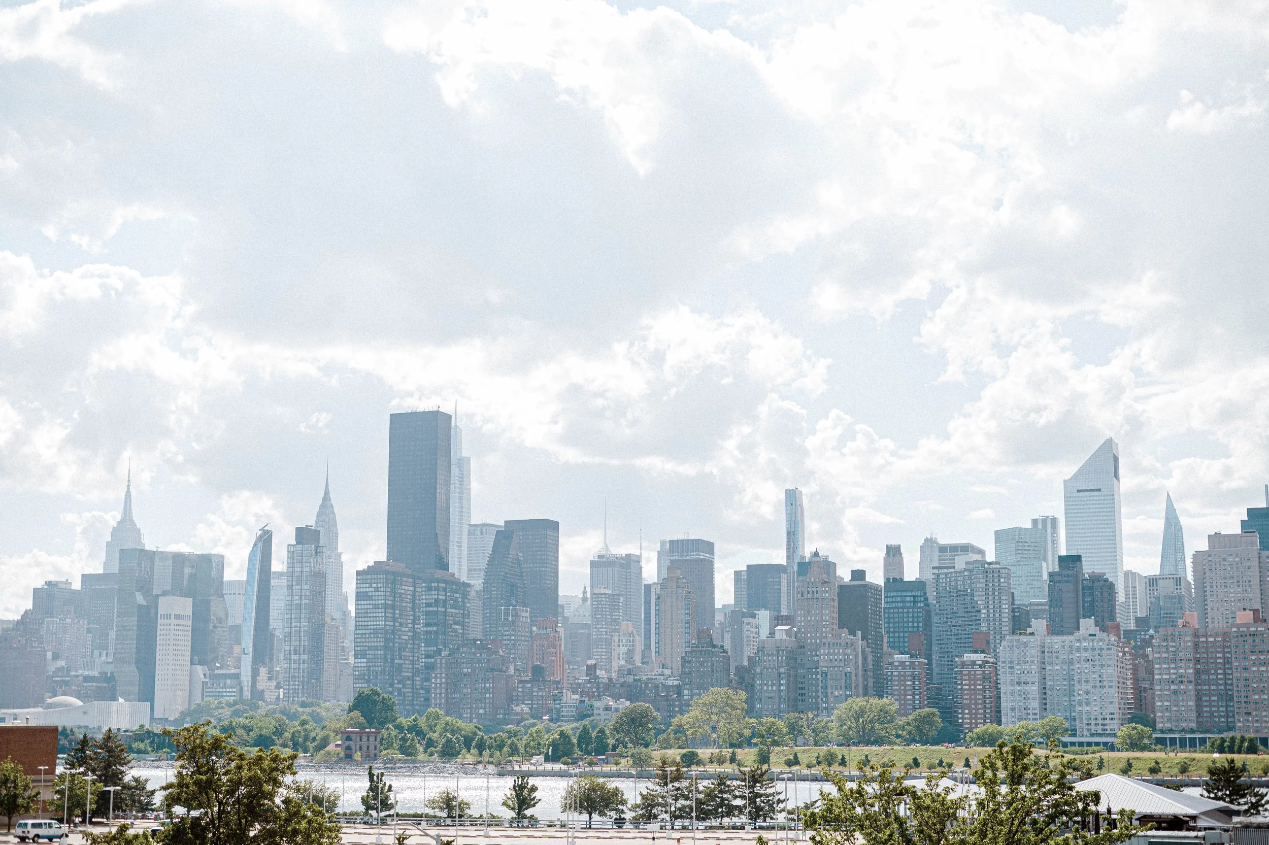 Panoramic view of the Midtown Manhattan skyline across the East River on a hazy day