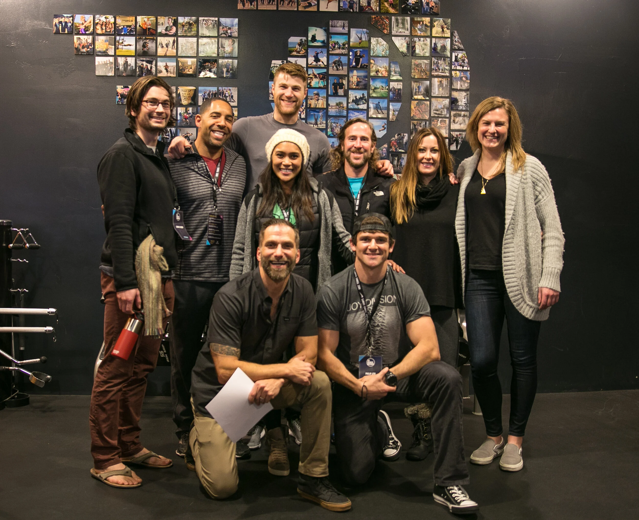 Group of nine fitness professionals posing together at a Business Movement event
