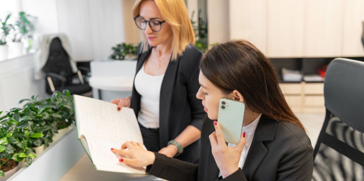 Two businesswomen collaborating in a bright office