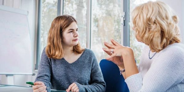 Two women in a coaching conversation at a table