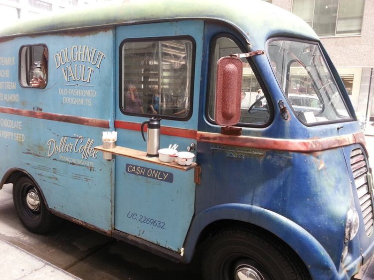 Vintage blue Doughnut Vault food truck parked on an urban street