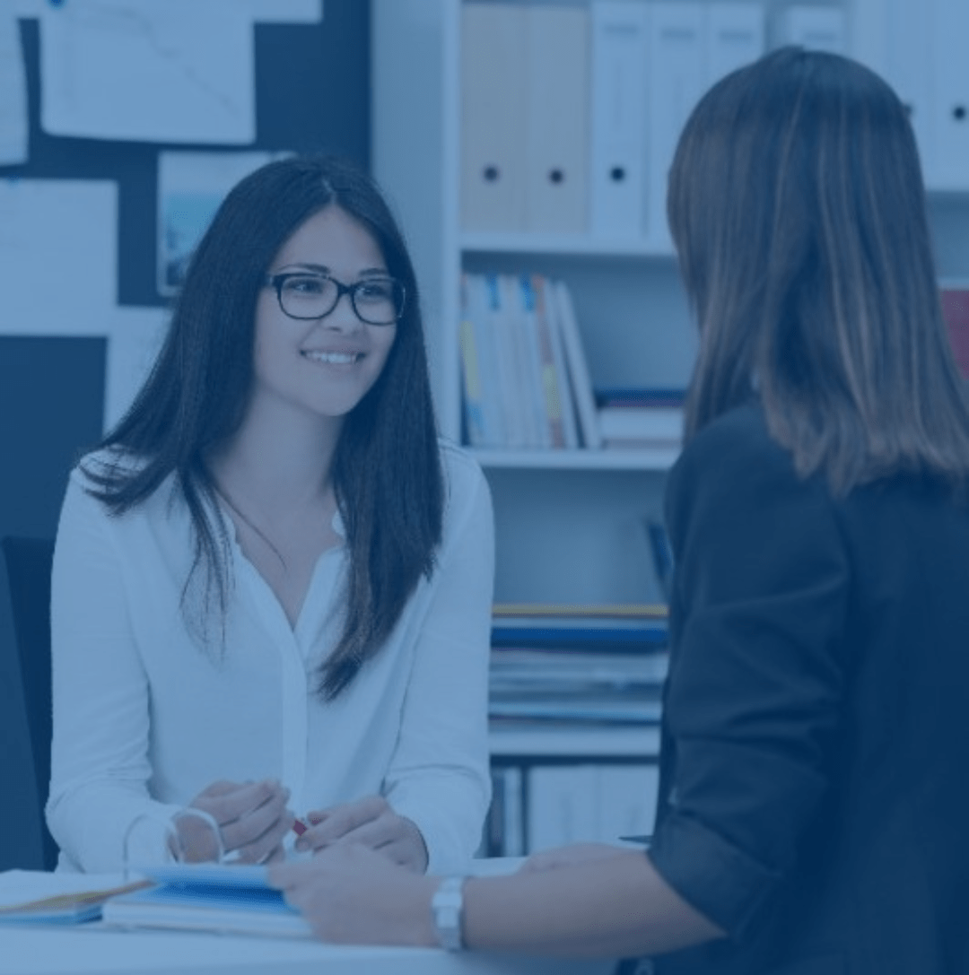 One-on-one coaching session between two women in an office