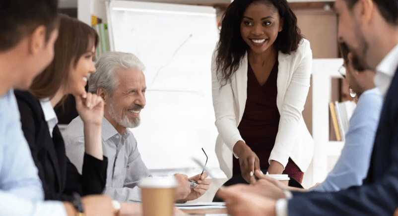 Colleagues in a meeting room, a leader presenting