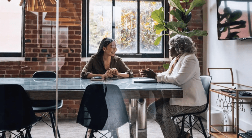 Two women in a mentoring conversation at a table