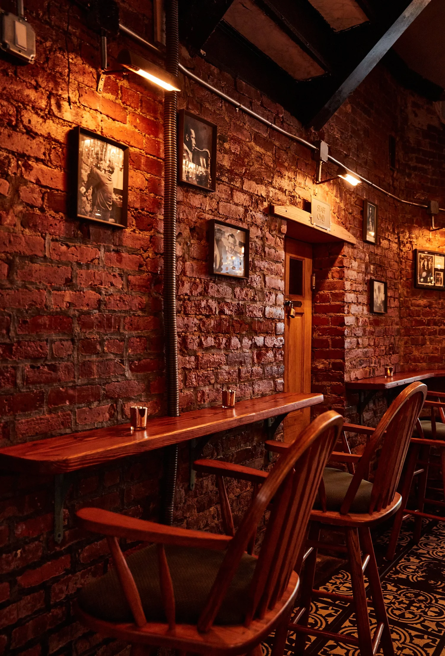 Bar seating and low lamps along the wall