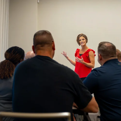 Andrea Singsaas speaking with a leadership team during a workshop
