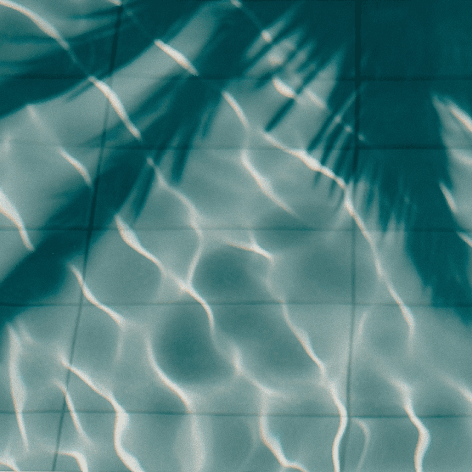 Sunlit turquoise water ripples