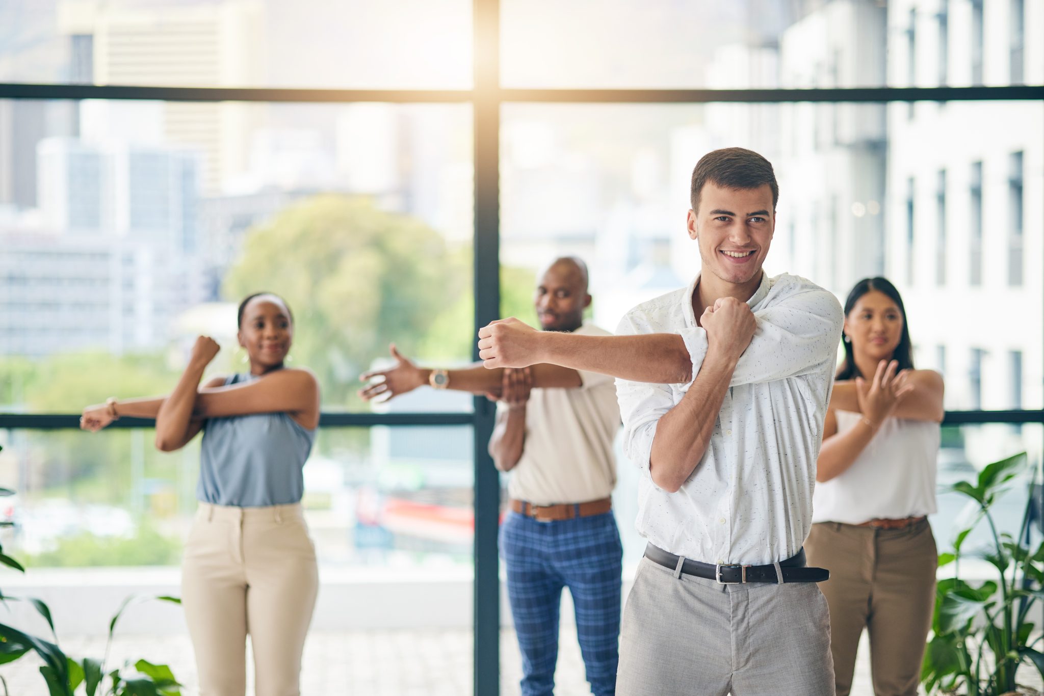Office colleagues stretching together during a workplace wellness session