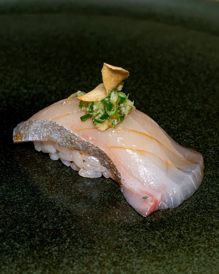 Shima aji nigiri with garlic chip and ginger scallion