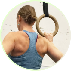 Woman holding gymnastic rings at a gym