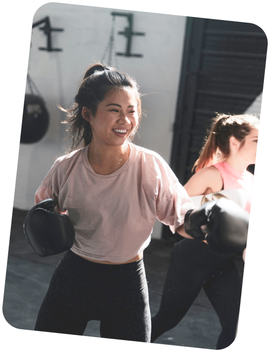 Smiling woman in boxing gloves during a kickboxing class