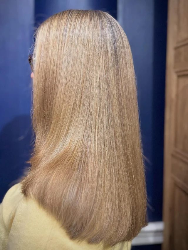 Back view of a client with long straight blonde hair