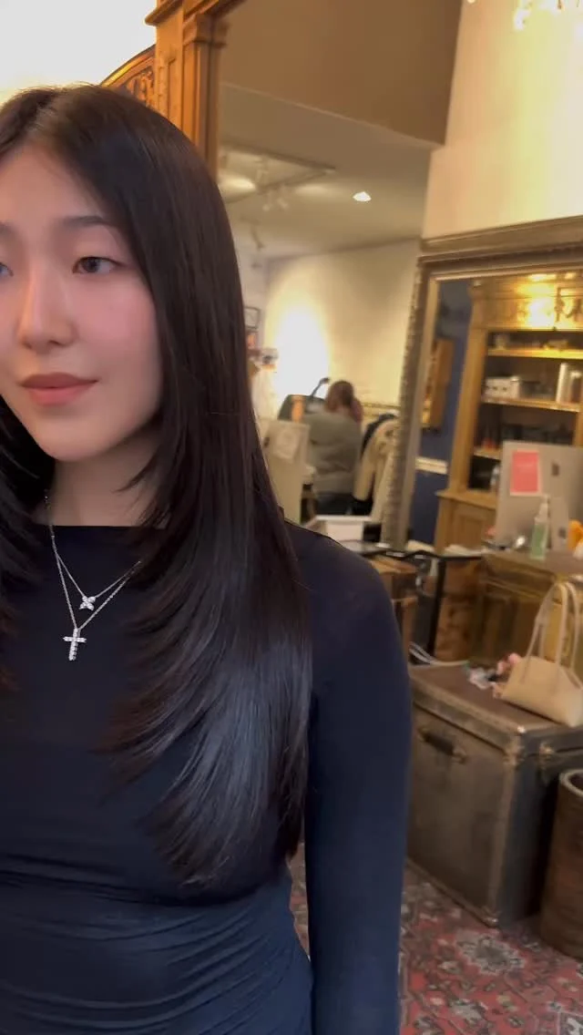 Client with sleek straight dark hair in the salon