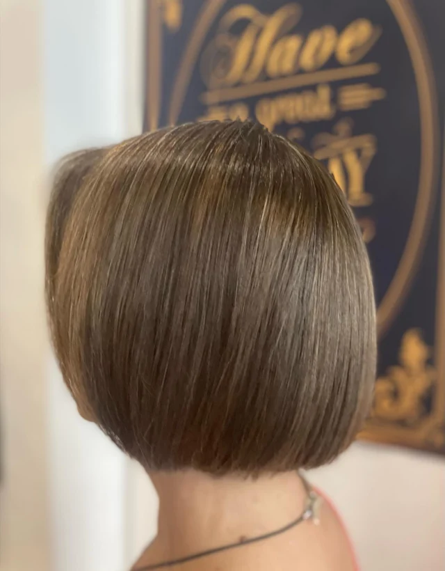 Back view of a client with a short dark brown bob haircut