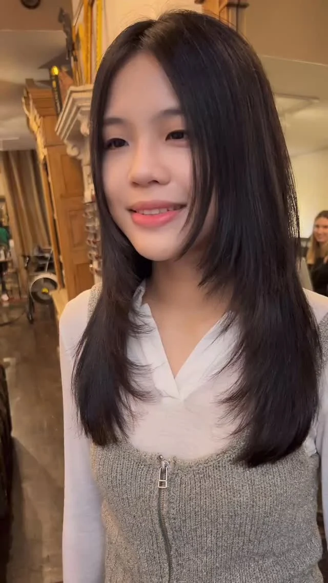 Client with a straight dark layered haircut in the salon