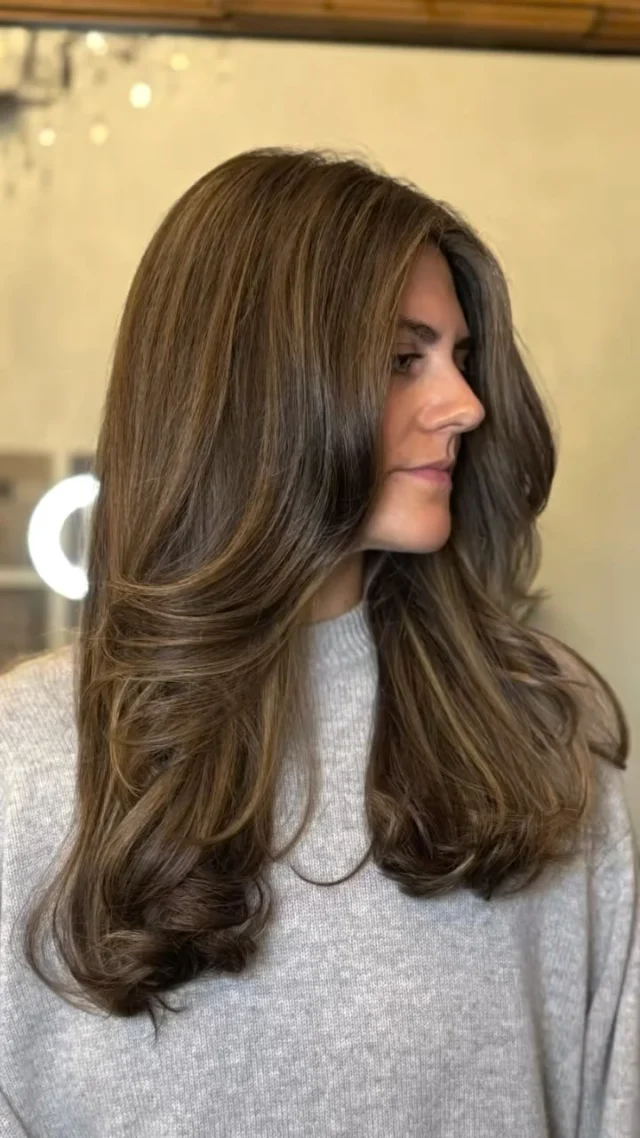 Client with long voluminous layered brunette hair