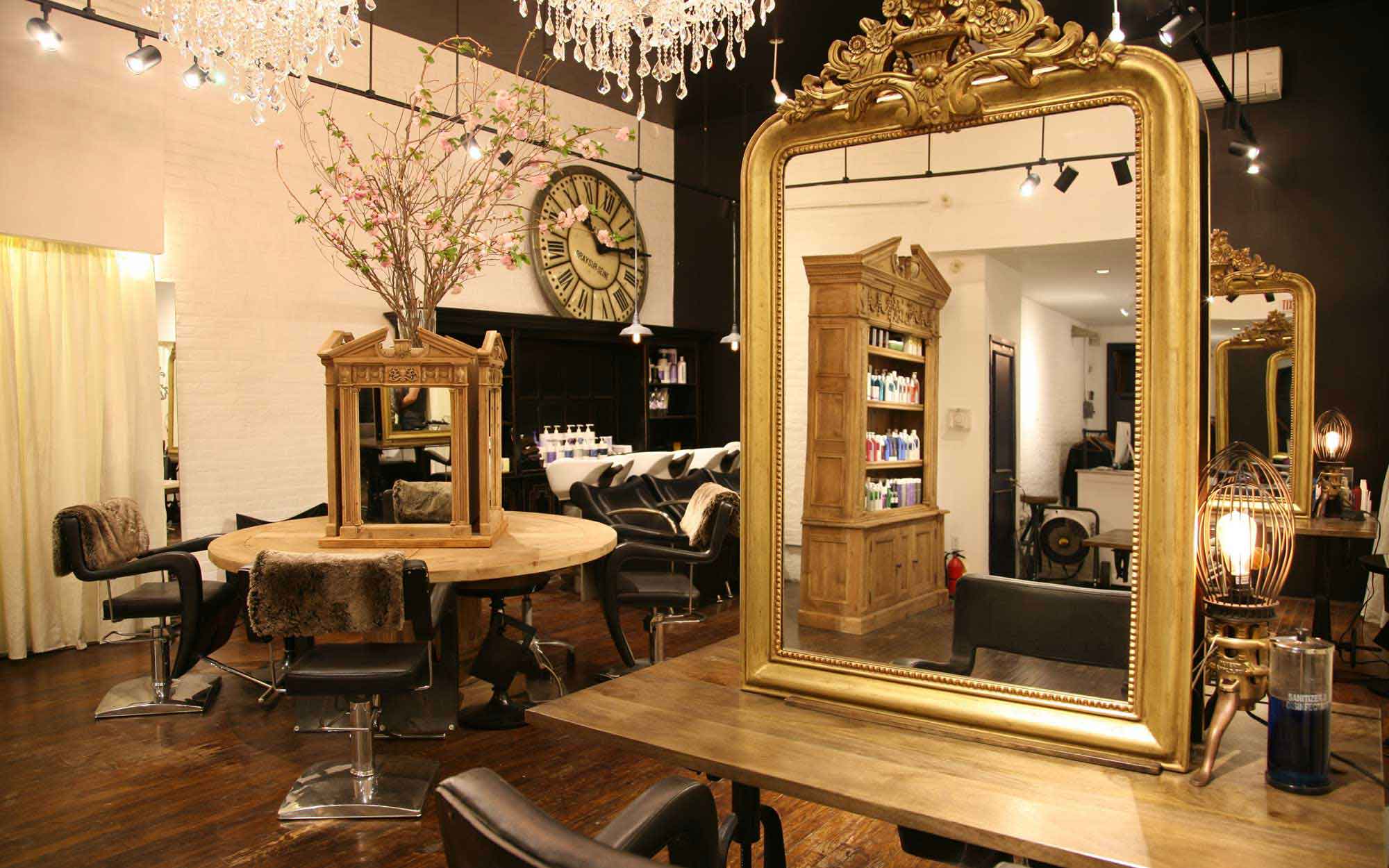 Tokuyama Salon interior with large gilded mirror, chandelier and black styling chairs