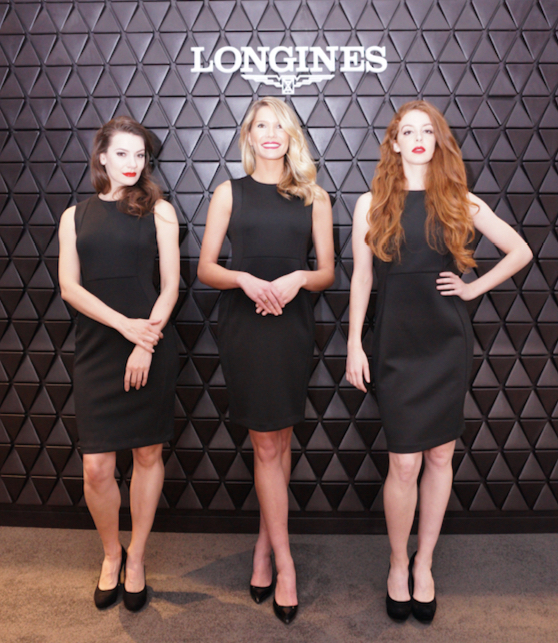 Brand ambassadors in black dresses before a Longines branded wall
