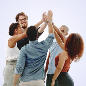 A diverse group of colleagues in a high-five circle outdoors