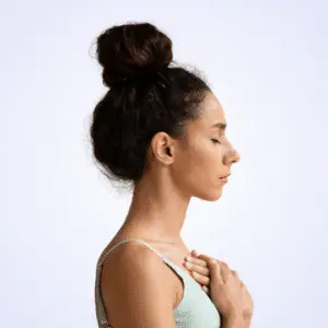 Woman in profile with a hand on her chest, eyes closed