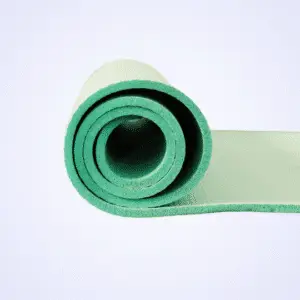 A rolled green yoga mat