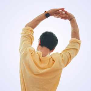 Person in a yellow shirt stretching their arms overhead