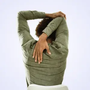 Person in a green top doing a shoulder stretch