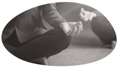 Person seated in meditation, hands in a mudra gesture