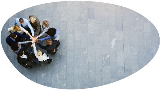 Overhead view of a team putting hands together in a huddle