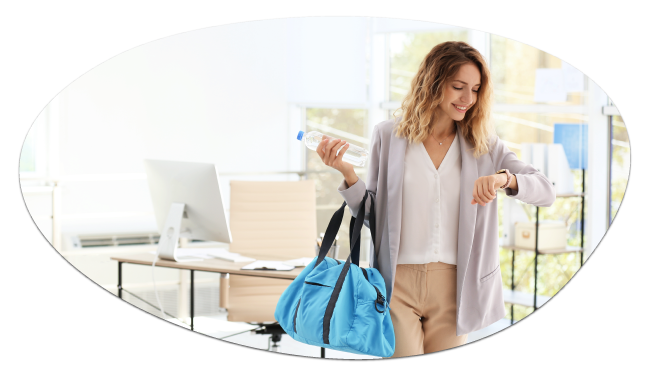 Smiling woman with a gym bag checking her smartwatch in an office