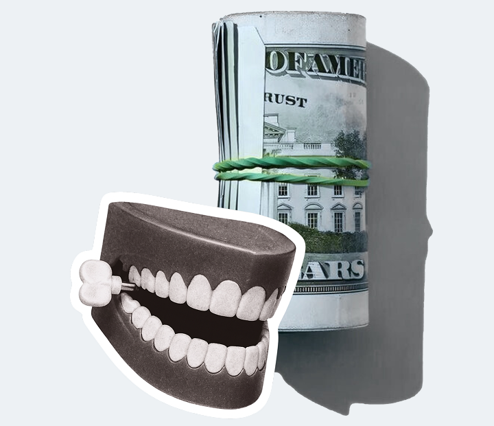 A roll of US dollar bills behind a wind-up chattering teeth toy