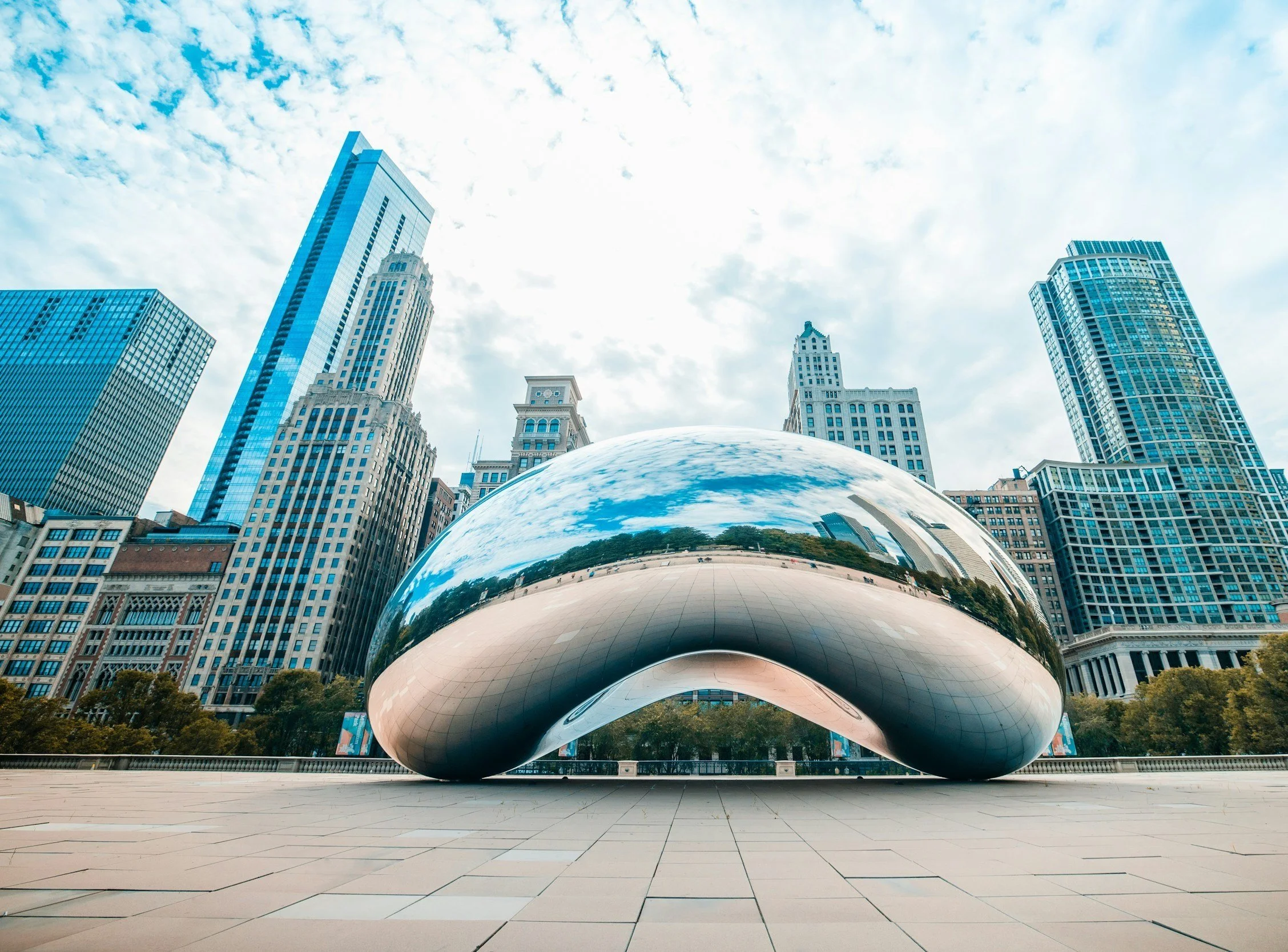 Cloud Gate (The Bean) sculpture in Millennium Park reflecting the Chicago skyline