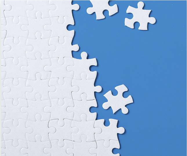 Jigsaw puzzle pieces coming together on a blue background