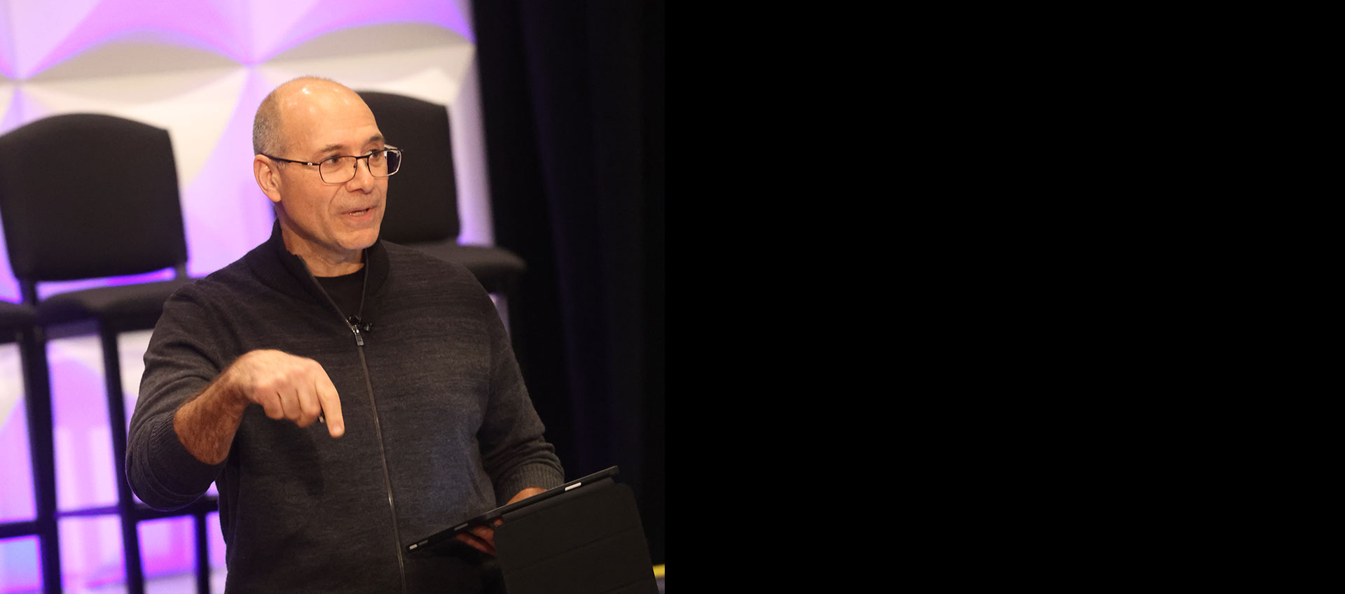 Basil Denno delivering a keynote on stage