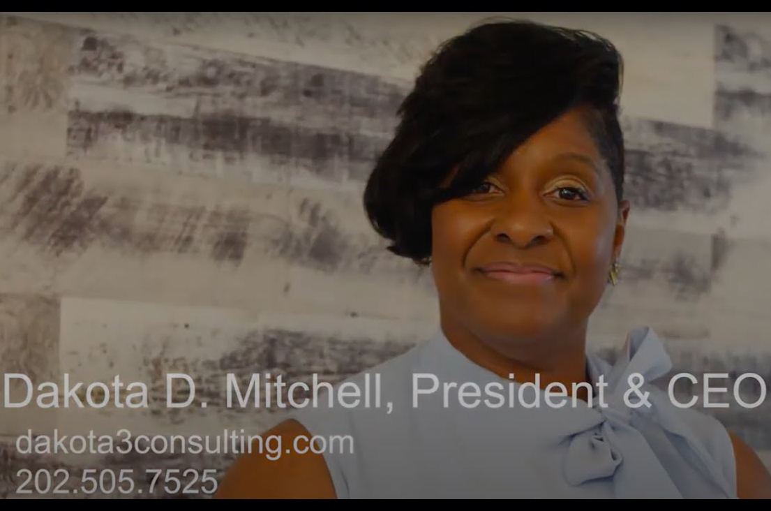 Dakota D. Mitchell, President & CEO of D3 Consulting, smiling in a blue bow-tie blouse