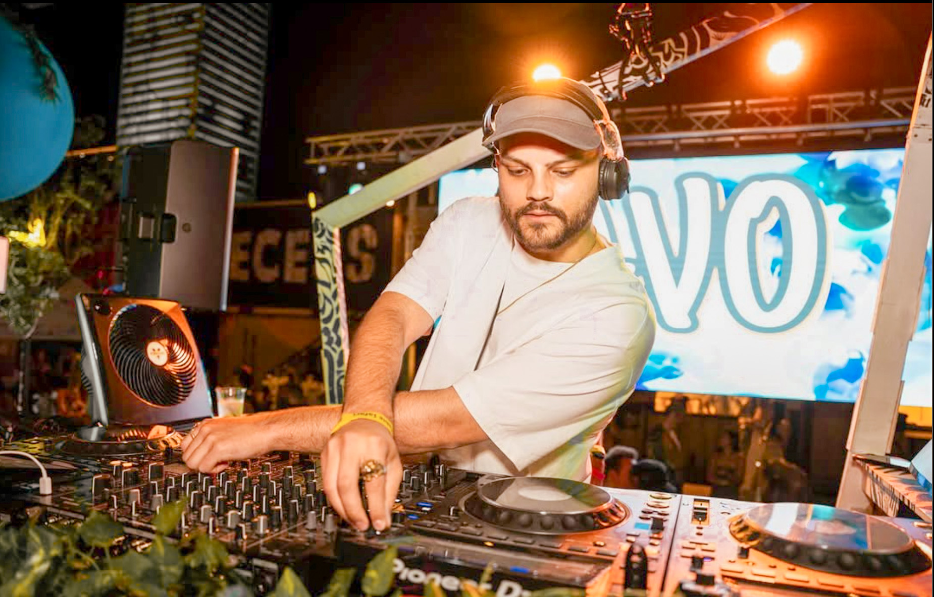 DJ at turntables at an outdoor nighttime event