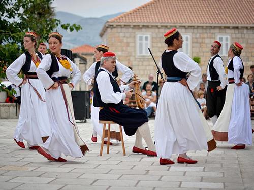Croatian folk dancers in traditional costume performing outdoors