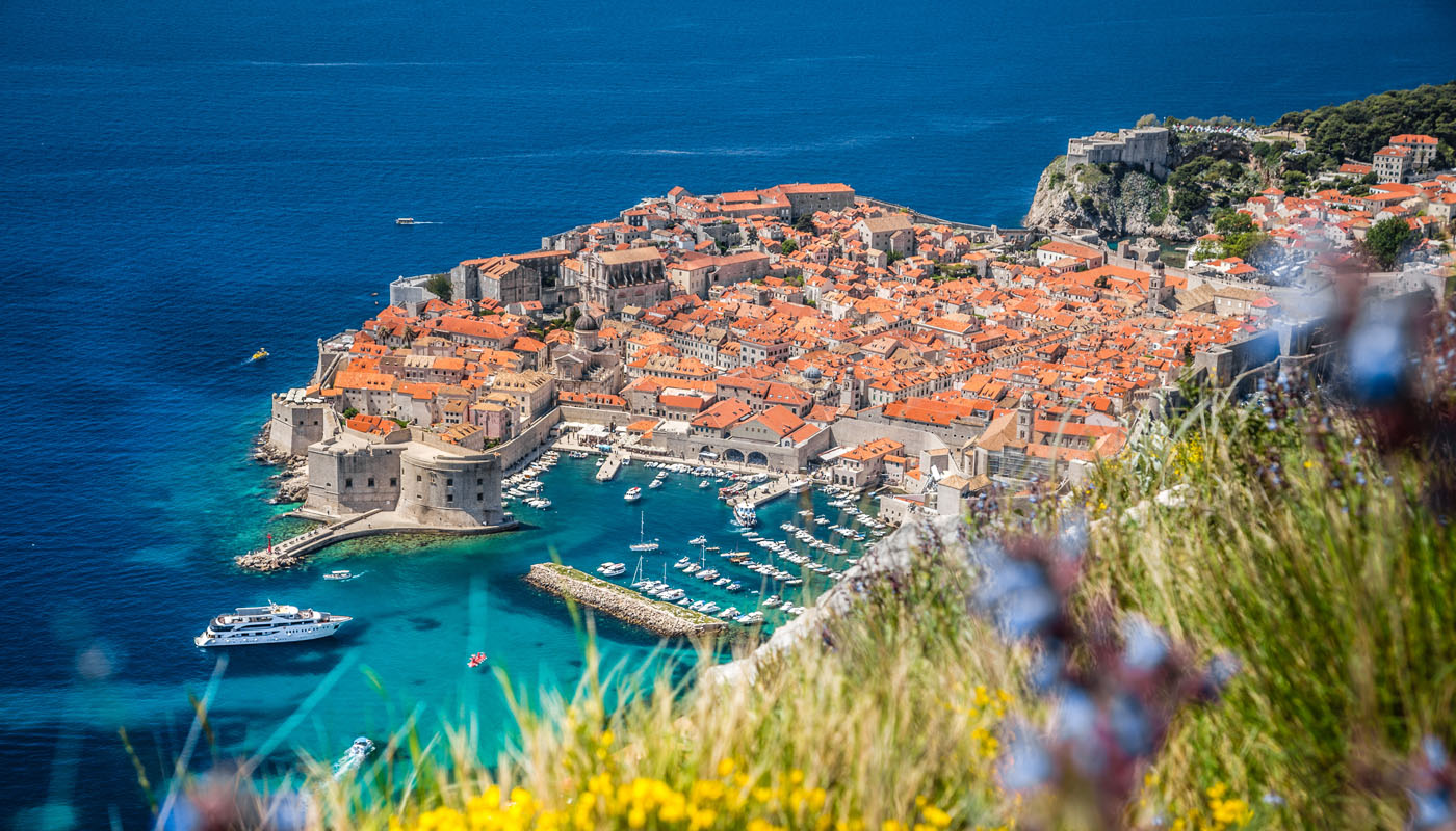 Aerial view of Dubrovnik old town with red rooftops, city walls and the Adriatic Sea