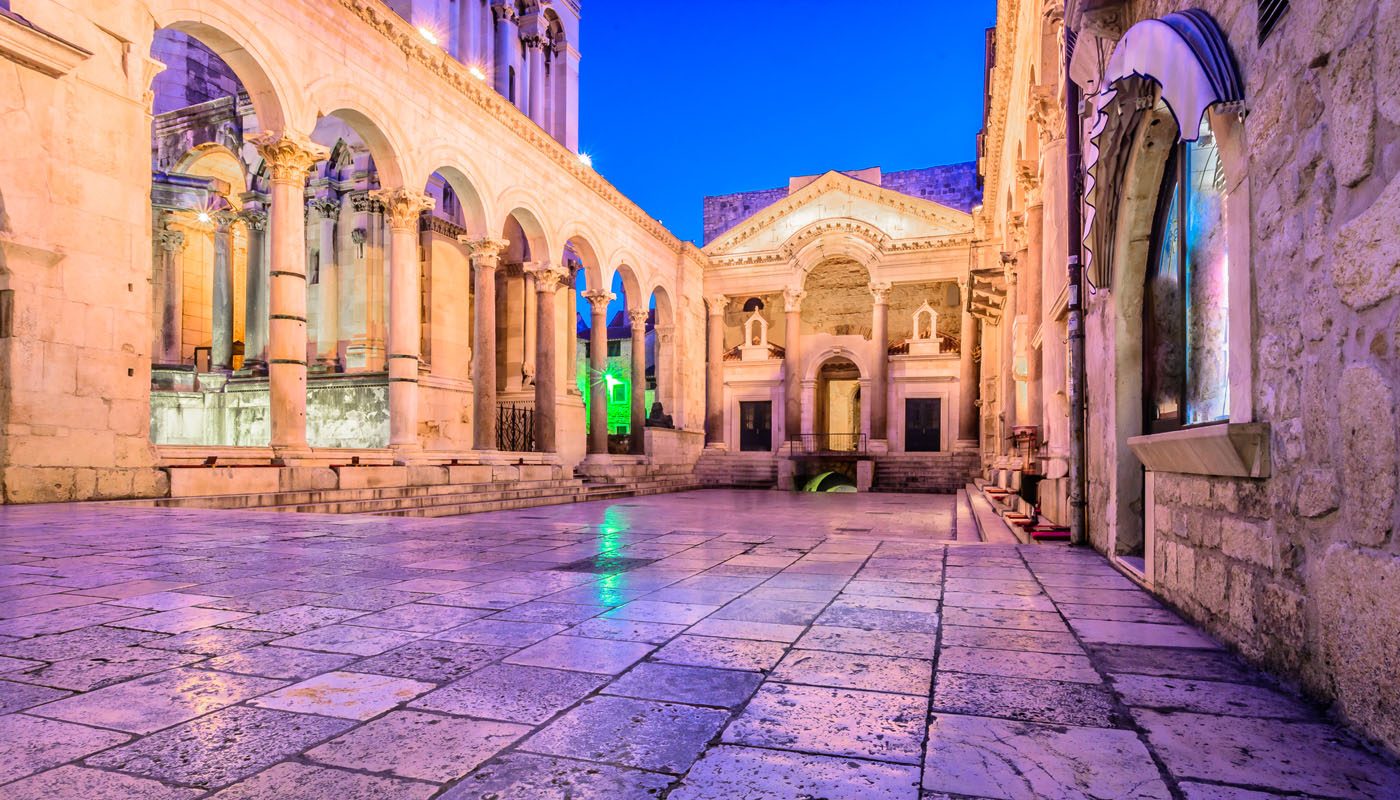 Diocletian's Palace peristyle in Split at night under purple and gold light
